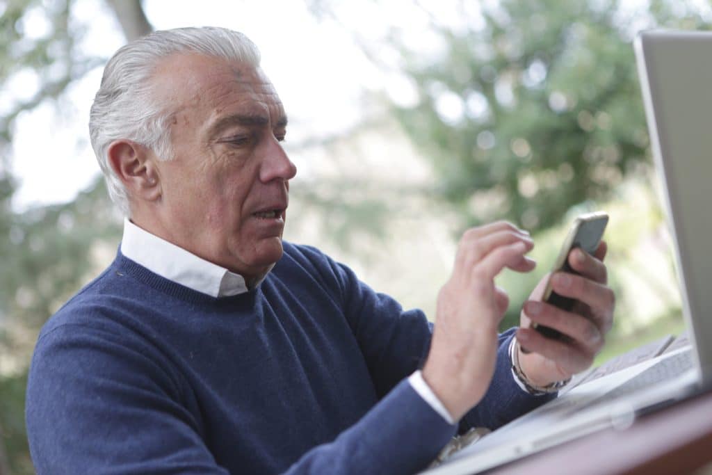 Man calculating how much he will have to pay for medical cost not covered by Medicare.